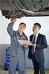 Mechanic Explaining to Businessman