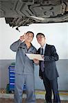 Mechanic Explaining to Businessman