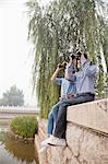 Young Couple Looking Out With Binoculars