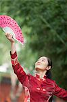 Young Woman Practicing Tai Ji With Traditional Chinese Fan