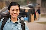 Student portrait in front of dormitory at college