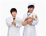 Boy and girl dressed up as doctors checking teddy bear's vital signs