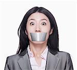 Businesswoman with her mouth caver with duct tape