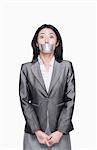 Businesswoman with her mouth caver with duct tape