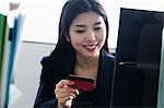 Businesswoman holding card in office