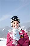 Young Woman Playing with Snow in Ski Resort