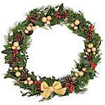 Christmas floral wreath decoration with baubles, gold  bow, holly, mistletoe and winter greenery over white background.