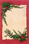 Christmas and winter decorative border with holly, mistletoe, ivy and cedar leaf spirgs over old parchment and red mottled background.