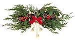 Christmas floral decoration with gold bells, red bow, holly, mistletoe, ivy, pinecones and winter greenery over white background.