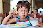 Cute little boy having delicious breakfast