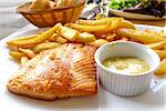 grilled salmon and fries - french cuisine dish with tomato and salmon