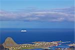 Luxurious cruiser under blue skies sailing along picturesque norwegian coast