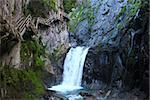 cliffside hiking steps near waterfall in switzerland