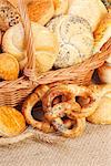 Composition of various baked products in basket on rustic background