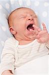 Closeup of Face of Yawning Lying Newborn Baby