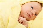 Newborn Baby in the Bed under Yellow Blanket