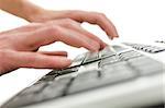 Closeup of  blurred hands typing on computer keyboard.