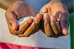 African girl hands holding rice.