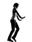 full length silhouette of a young man dancer moonwalk dancing funky hip hop r&b on  isolated  studio white background