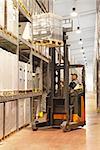 Loading pallet with forklift in distribution warehouse