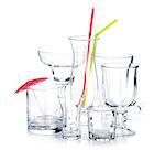 Cocktail glasses with drinking straws and umbrella. Isolated on white background