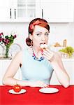 Beautiful woman eating cake on the kitchen