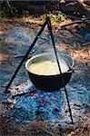 Tourist kettle above a fire with fish soup