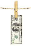 dollar bill is hanging on a rope with wooden clothespin. isolated on white.
