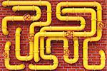 yellow gas pipes on a brick wall.