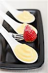 custard pastry cream and strawberry on a fork