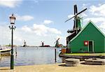 dutch windmills over river in Zaanse Schans in sunny day, Netherlands