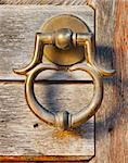 old brass door handle on wooden gate