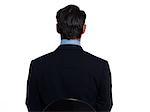 Handsome caucasian man businessman sitting portrait on white isolated background