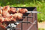 Shashlik (shish kebab) prepared on the metal skewers outdoor