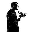 silhouette caucasian business man offering flowers expressing behavior full length on studio isolated white background