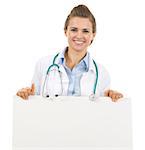 Smiling doctor woman showing blank billboard