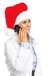 Happy doctor woman in santa hat talking mobile phone