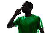 one african man soccer player hushing green jersey in silhouette  on white background