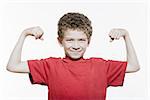 little caucasian strong boy portrait flexing muscle biceps mischief isolated studio on white background