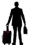 rear view one caucasian business traveler man walking with suitcase standing  full length silhouette in studio isolated white backgroun