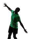 one african man soccer player scoring green jersey in silhouette  on white background