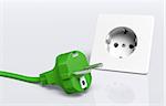 ecological european disconnected green plug lies on the ground in front of a white socket