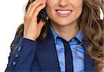 Closeup on happy business woman talking cell phone