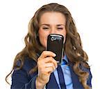 Closeup on business woman taking photo with cell phone