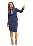 Full length portrait of smiling business woman pointing on copy space