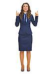 Full length portrait of smiling business woman pointing up on copy space