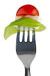 Caprese salad ingredients on the fork isolated on white.