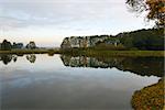 Autumn landscape with water and reflection of clouds