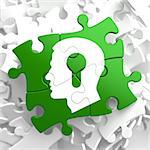 Psychological Concept - Profile of Head with a Keyhole Located on Green Puzzle Pieces.