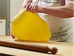 Close-up of elderly Italian woman making pasta by hand in kitchen, working with dough, Ontario, Canada